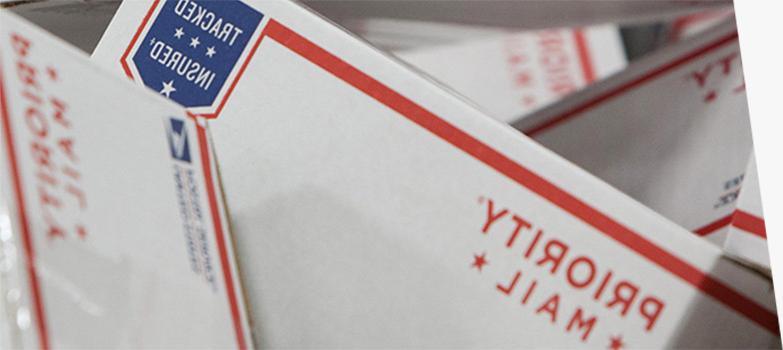 Image of priority mail boxes stacked on top of one another.